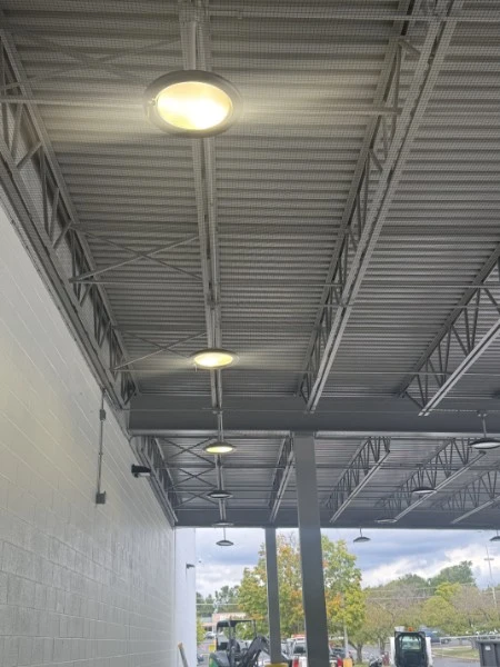 Commercial bird netting installation beneath an Amazon warehouse loading dock canopy in Waynesboro Virginia
